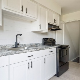 kitchen with white cabinets and black appliances